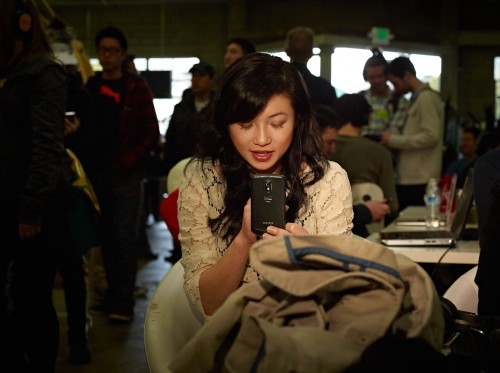 Checking Her Cell Phone by Peter Adams.